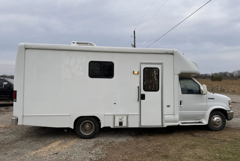 Interior of a mobile veterinary clinic with surgical and examination equipment, representing the challenges of managing multiple business operations.
